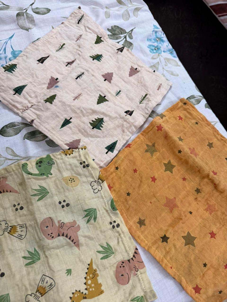 Herbal-dyed organic cotton swaddle wrapped around a sleeping baby.